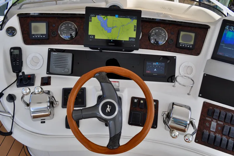 King Leisure Yacht Photos Pics 2002 Sea Ray 480 Sedan Bridge helm with navigation screens and wooden steering wheel.