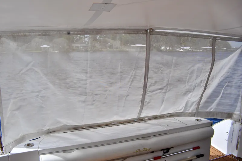 King Leisure Yacht Photos Pics 2002 Sea Ray 480 Sedan Bridge boat interior with water view through clear enclosure.