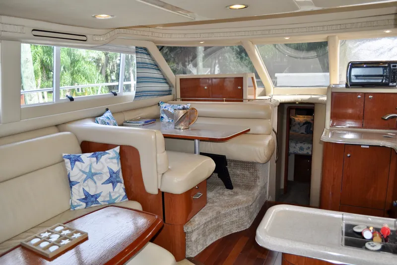 King Leisure Yacht Photos Pics Luxurious interior of 2002 Sea Ray 480 Sedan Bridge yacht with plush seating and wood accents.