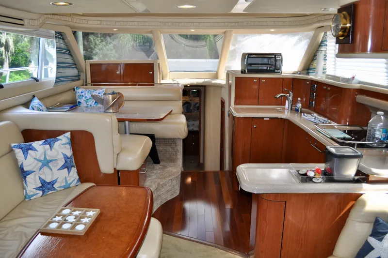 King Leisure Yacht Photos Pics Interior of 2002 Sea Ray 480 Sedan Bridge yacht with elegant seating and kitchen area.