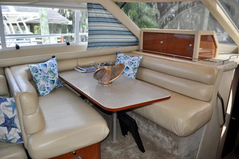 King Leisure Yacht Photos Pics Luxurious interior of 2002 Sea Ray 480 Sedan Bridge with plush seating and decorative pillows.