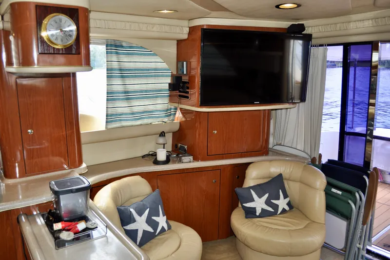 King Leisure Yacht Photos Pics Luxurious interior of 2002 Sea Ray 480 Sedan Bridge with leather seating and modern amenities.
