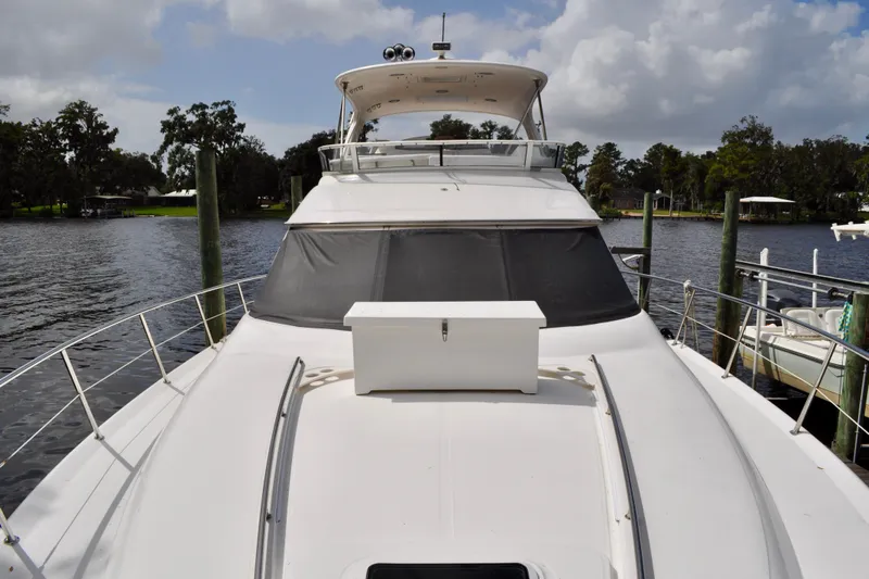 King Leisure Yacht Photos Pics 2002 Sea Ray 480 Sedan Bridge yacht docked on a serene river.