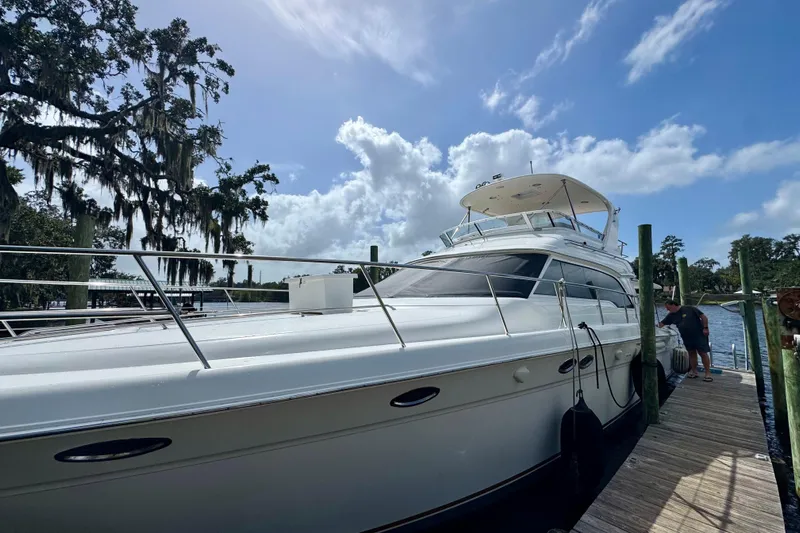 King Leisure Yacht Photos Pics 2002 Sea Ray 480 Sedan Bridge yacht docked under a clear blue sky.