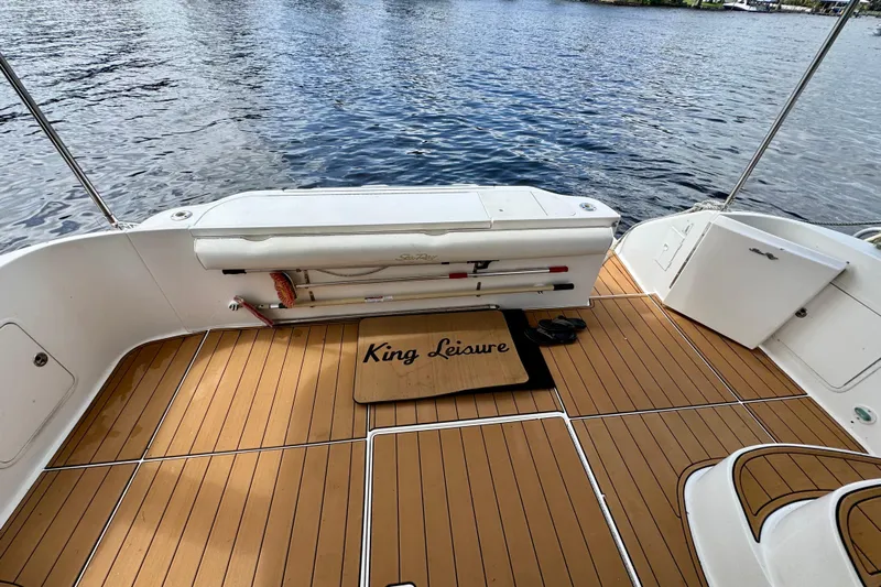 King Leisure Yacht Photos Pics 2002 Sea Ray 480 Sedan Bridge deck with "King Leisure" mat, overlooking water.