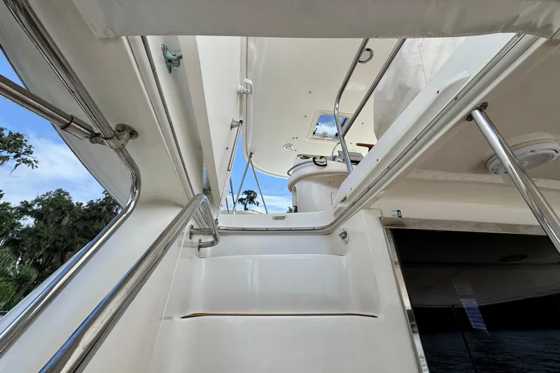 King Leisure Yacht Photos Pics Staircase view on 2002 Sea Ray 480 Sedan Bridge yacht, featuring sleek railings and open sky.