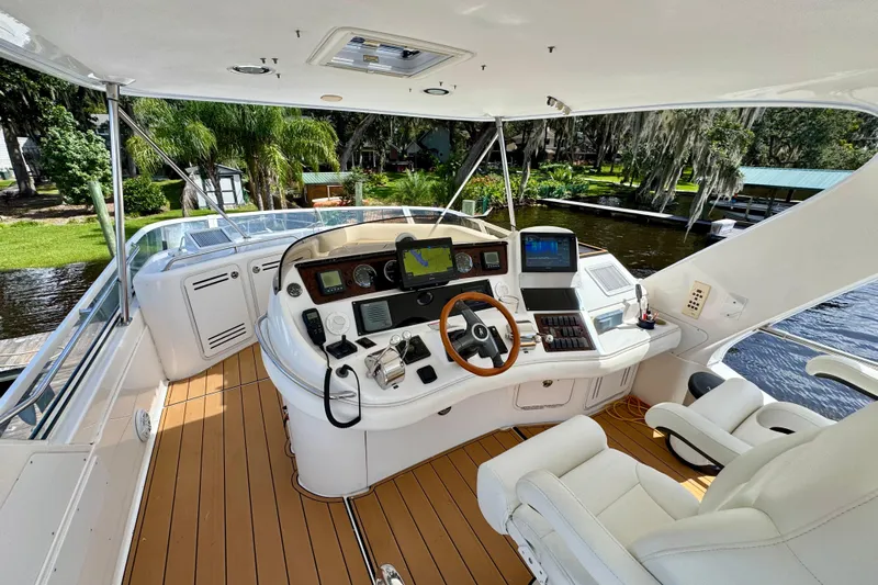 King Leisure Yacht Photos Pics 2002 Sea Ray 480 Sedan Bridge yacht helm with modern navigation equipment and luxurious seating.