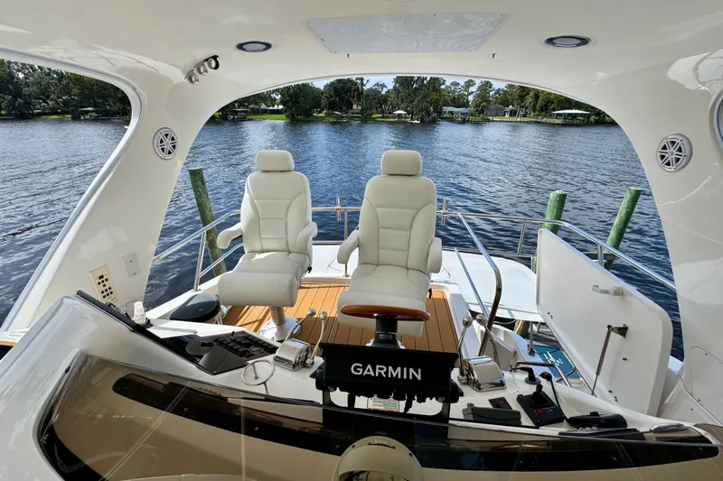 King Leisure Yacht Photos Pics 2002 Sea Ray 480 Sedan Bridge helm with Garmin system, overlooking serene water view.