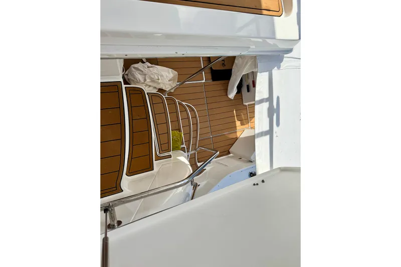 King Leisure Yacht Photos Pics 2002 Sea Ray 480 Sedan Bridge boat deck with wooden flooring and railing.