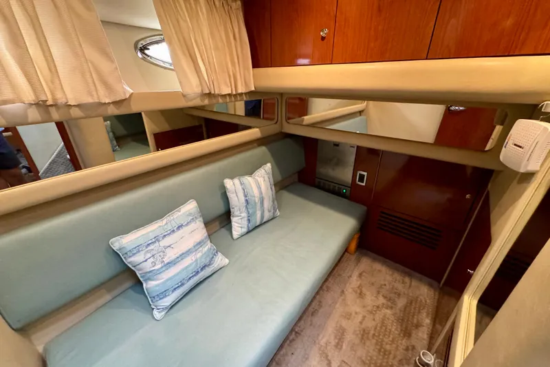 King Leisure Yacht Photos Pics Interior of 2002 Sea Ray 480 Sedan Bridge with cushioned seating and decorative pillows.
