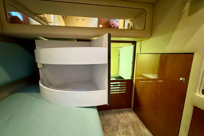 King Leisure Yacht Photos Pics Interior of 2002 Sea Ray 480 Sedan Bridge with storage and wooden cabinetry.