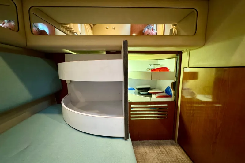 King Leisure Yacht Photos Pics 2002 Sea Ray 480 Sedan Bridge interior with storage compartments and seating area.