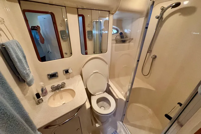 King Leisure Yacht Photos Pics Luxurious bathroom in 2002 Sea Ray 480 Sedan Bridge yacht, featuring shower and vanity.