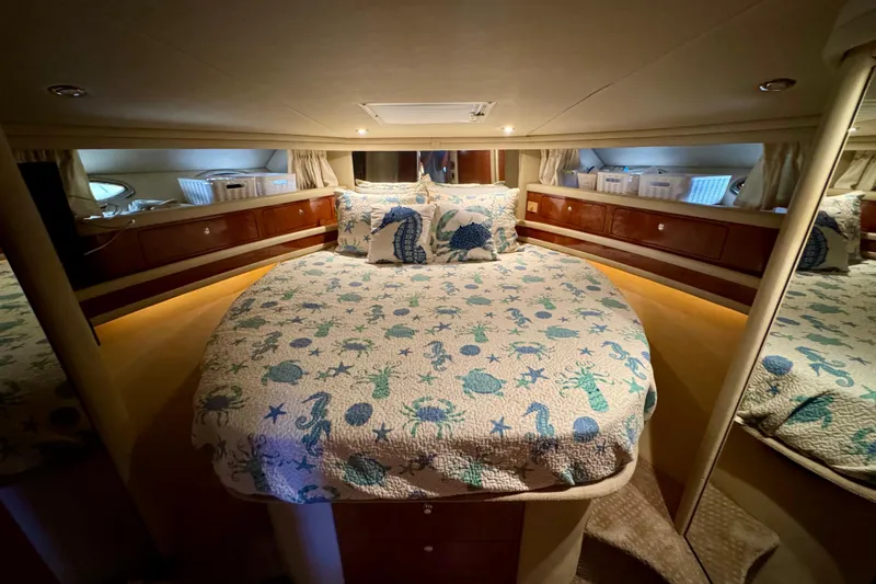 King Leisure Yacht Photos Pics Luxurious 2002 Sea Ray 480 Sedan Bridge bedroom with nautical-themed bedding.