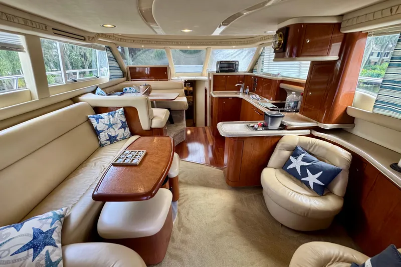 King Leisure Yacht Photos Pics Luxurious interior of 2002 Sea Ray 480 Sedan Bridge yacht with plush seating and elegant wood finishes.