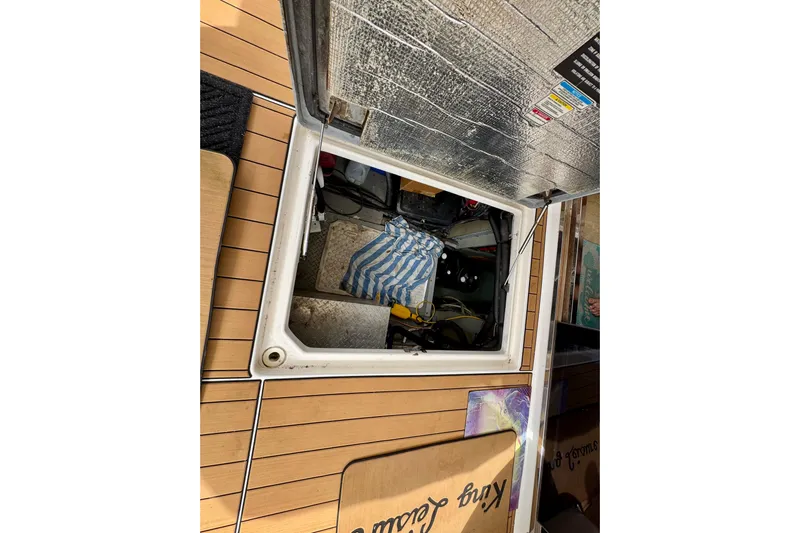 King Leisure Yacht Photos Pics Open hatch on 2002 Sea Ray 480 Sedan Bridge, revealing interior storage space.