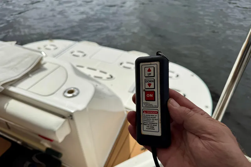 King Leisure Yacht Photos Pics Hand holding remote control on 2002 Sea Ray 480 Sedan Bridge boat deck.