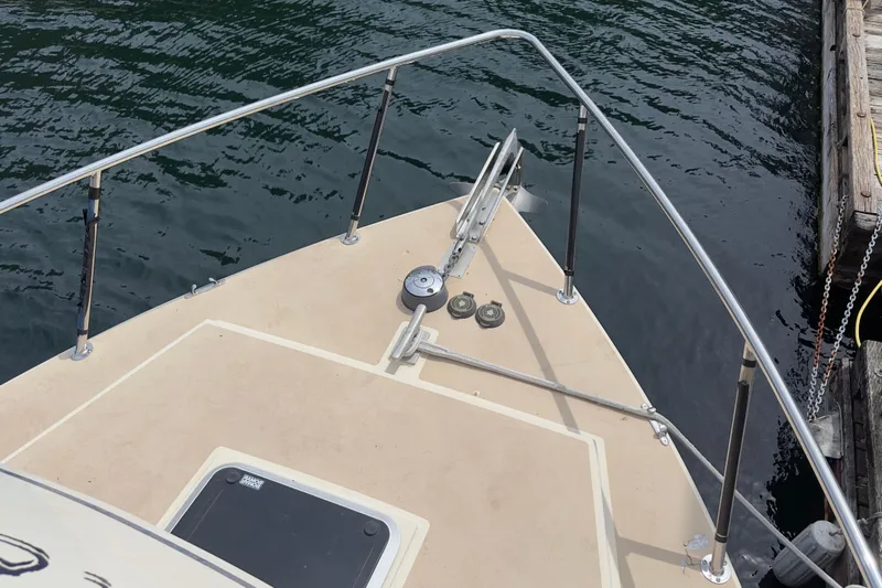 Blue Heron Yacht Photos Pics Bow of 2003 Coastal Craft 320 Cruiser at dock, featuring stainless steel railings.