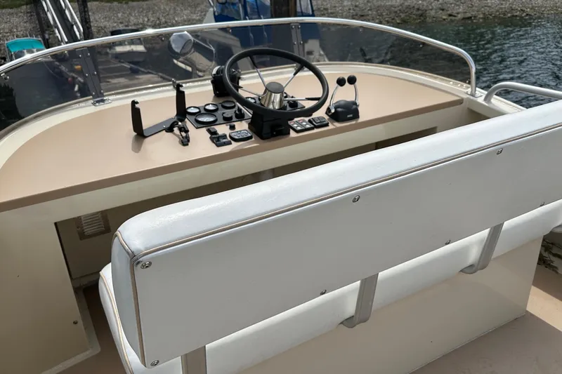 Blue Heron Yacht Photos Pics Helm of 2003 Coastal Craft 320 Cruiser with steering wheel and controls.