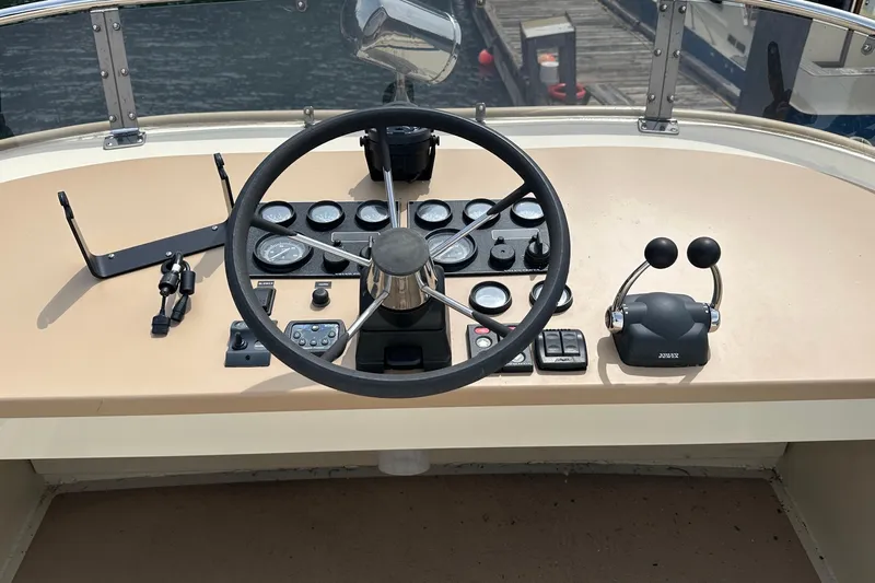 Blue Heron Yacht Photos Pics 2003 Coastal Craft 320 Cruiser helm with steering wheel and control panel.