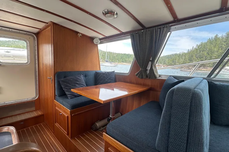 Blue Heron Yacht Photos Pics Interior of 2003 Coastal Craft 320 Cruiser with wood finish and scenic window view.