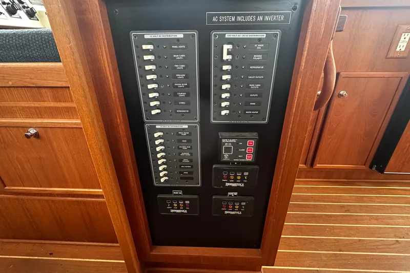 Blue Heron Yacht Photos Pics Electrical panel of a 2003 Coastal Craft 320 Cruiser, featuring AC and DC distribution.
