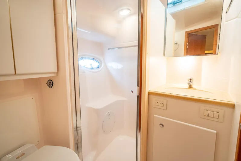  Yacht Photos Pics Bathroom interior of 2005 Tiara Yachts 4200 Open, featuring modern fixtures and lighting.