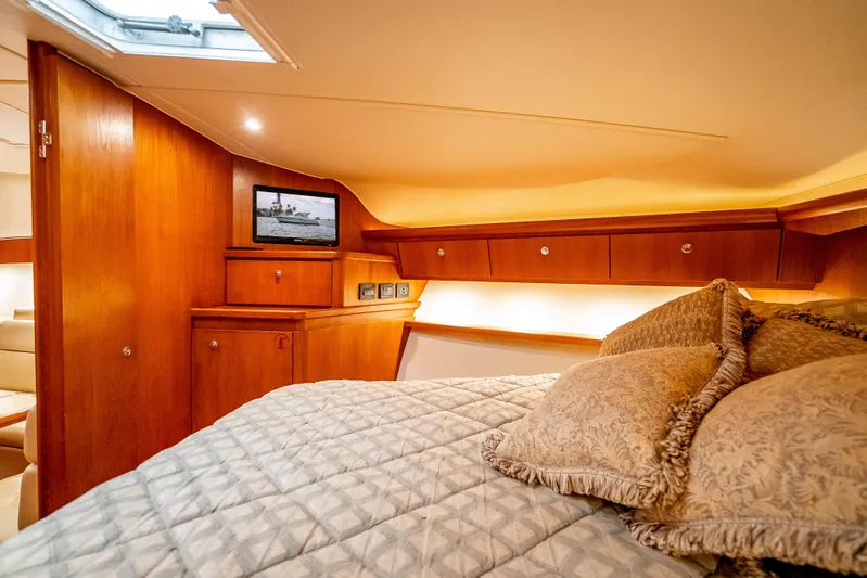  Yacht Photos Pics Luxurious cabin interior of 2005 Tiara Yachts 4200 Open with cozy bedding and wood finish.