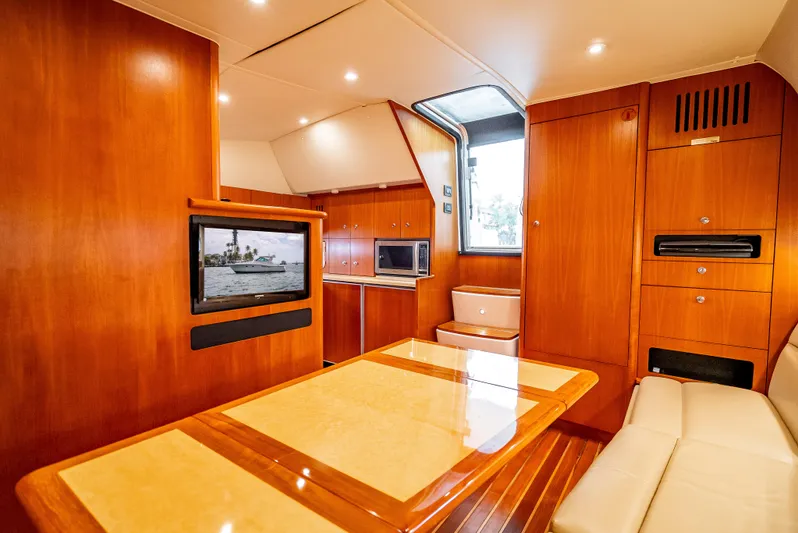  Yacht Photos Pics 2005 Tiara Yachts 4200 Open interior with wood finish, dining table, and modern amenities.