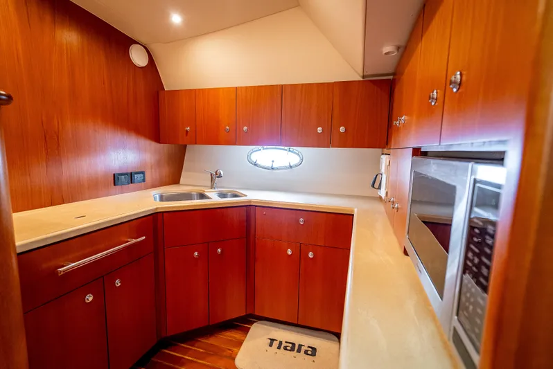  Yacht Photos Pics 2005 Tiara Yachts 4200 Open kitchen with wood cabinetry and modern appliances.