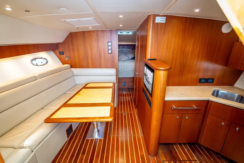  Yacht Photos Pics 2005 Tiara Yachts 4200 Open interior with wood finish, seating, and kitchenette.