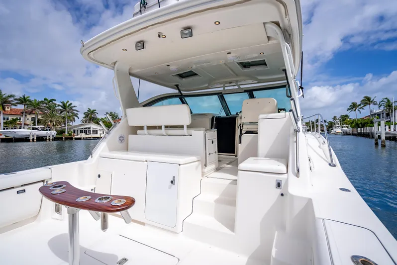  Yacht Photos Pics 2005 Tiara Yachts 4200 Open, spacious deck, luxurious seating, docked by palm-lined waterfront.