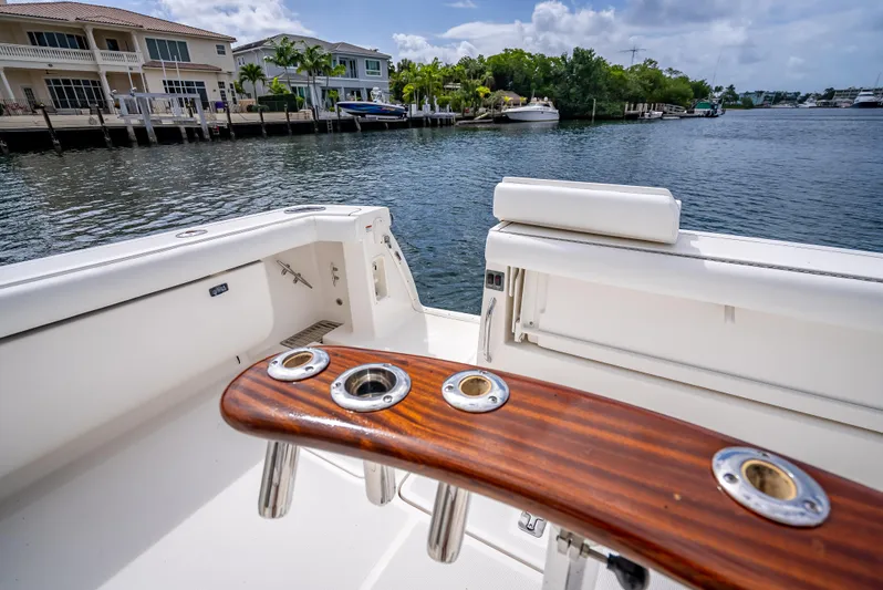  Yacht Photos Pics 2005 Tiara Yachts 4200 Open boat with rod holders, docked near waterfront homes.