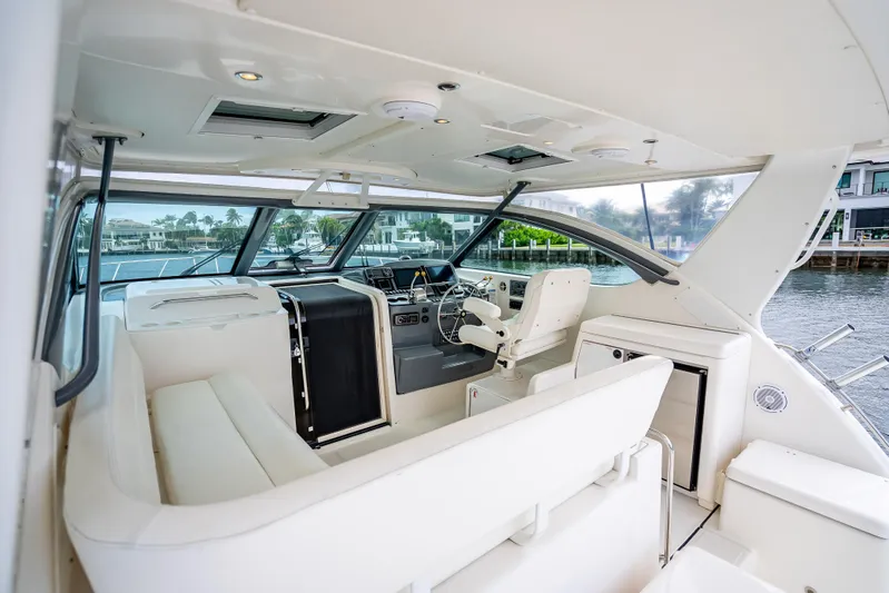  Yacht Photos Pics 2005 Tiara Yachts 4200 Open interior with white seating and helm, dockside view.