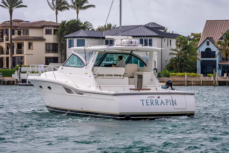  Yacht Photos Pics 2005 Tiara Yachts 4200 Open boat named Terrapin on water near luxury homes.