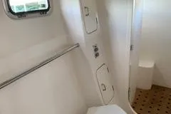 Casuarina Yacht Photos Pics Interior of 2000 Voyage Yachts Norseman 430, featuring bathroom with window and storage compartments.