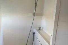 Casuarina Yacht Photos Pics Shower area in 2000 Voyage Yachts Norseman 430, featuring sleek white design.