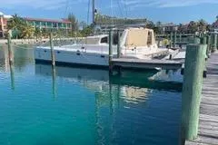 Casuarina Yacht Photos Pics 2000 Voyage Yachts Norseman 430 catamaran docked in clear blue marina.