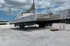 Casuarina Yacht Photos Pics 2000 Voyage Yachts Norseman 430 catamaran on dry dock under a cloudy sky.