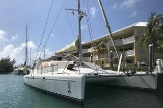 Casuarina Yacht Photos Pics 2000 Voyage Yachts Norseman 430 catamaran docked near waterfront buildings.