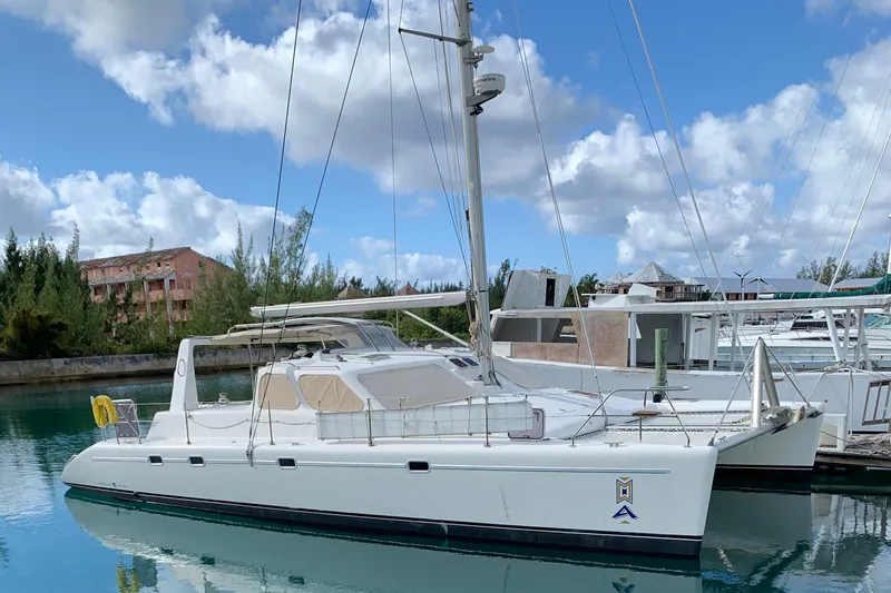 Casuarina Yacht Photos Pics 2000 Voyage Yachts Norseman 430 catamaran docked in a marina under a blue sky.