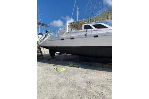 Casuarina Yacht Photos Pics 2000 Voyage Yachts Norseman 430 catamaran on dry dock under clear blue sky.