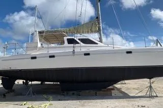 Casuarina Yacht Photos Pics 2000 Voyage Yachts Norseman 430 catamaran on land, clear sky background.