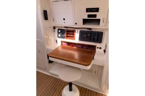 Casuarina Yacht Photos Pics Navigation station of 2000 Voyage Yachts Norseman 430 with wooden desk and control panels.