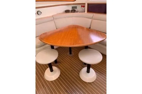 Casuarina Yacht Photos Pics Interior of 2000 Voyage Yachts Norseman 430 with triangular table and cushioned seating.