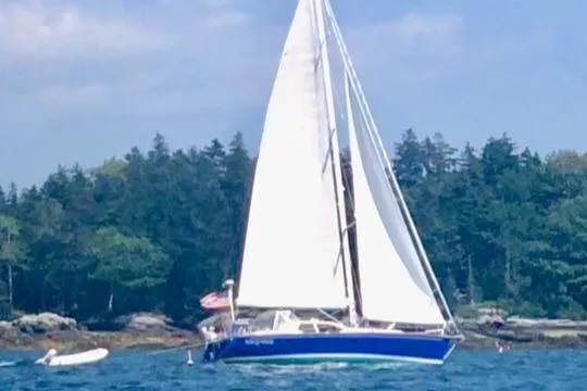 Custom Yacht Photos Pics Sailing yacht Sabre 452 from 2000 on a scenic waterway with forested background.