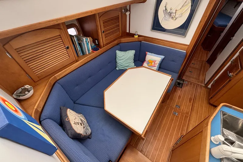 Custom Yacht Photos Pics Cozy interior of 2000 Sabre 452 yacht with blue seating and wooden accents.