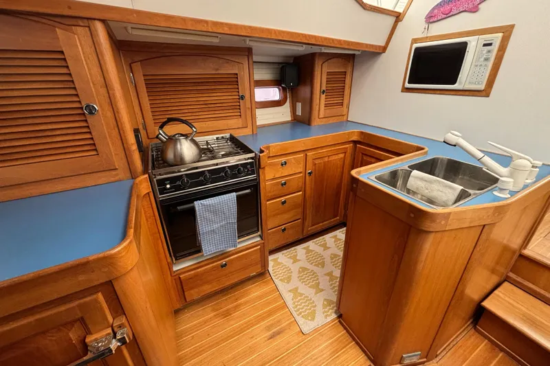 Custom Yacht Photos Pics Wooden yacht kitchen with stove, sink, and microwave; Sabre 452, year 2000.