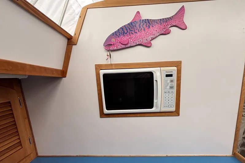 Custom Yacht Photos Pics Microwave in Sabre 452 boat interior with pink fish wall decor, 2000 model.