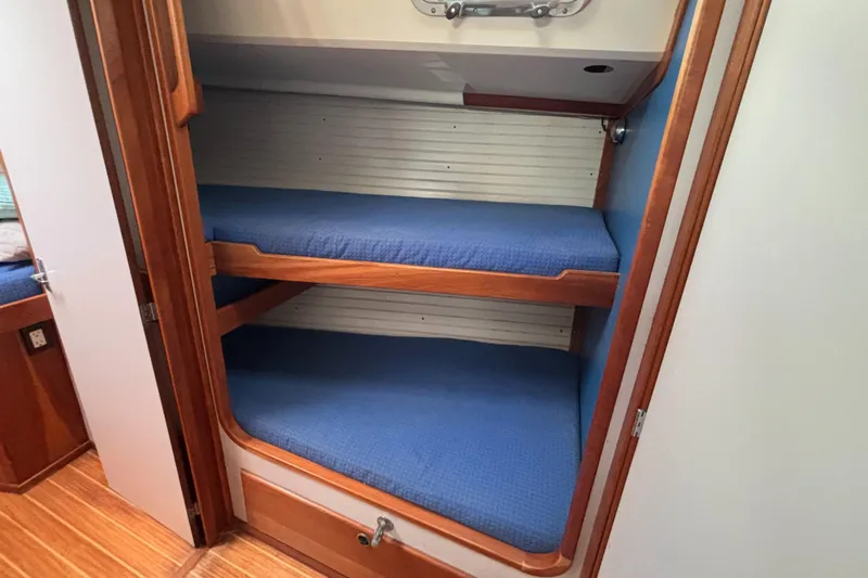 Custom Yacht Photos Pics Bunk beds with blue cushions in a 2000 Sabre 452 yacht cabin.
